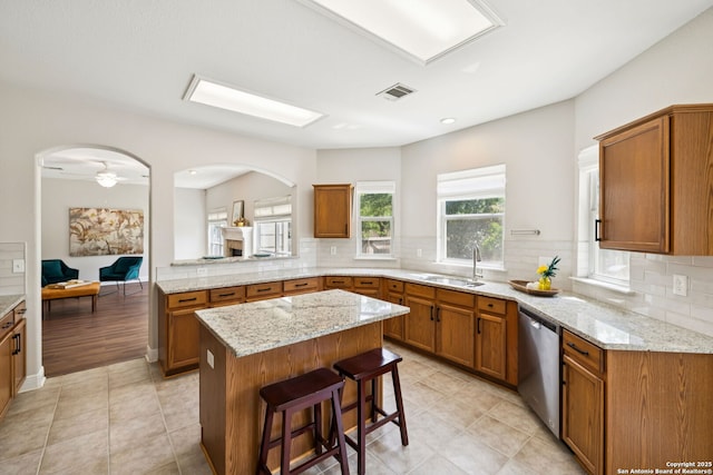 18310 Redwood Path, San Antonio, TX 78259 - kitchen with stainless steel dishwasher, a center island, brown cabinetry, and recessed lighting