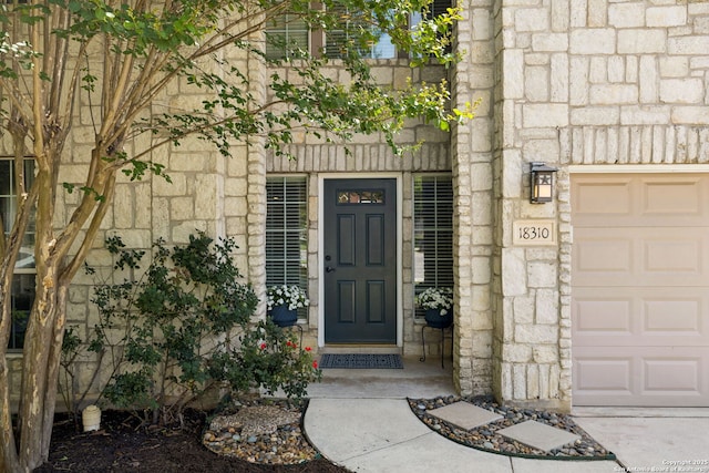 18310 Redwood Path, San Antonio, TX 78259 - view of exterior entry featuring stone siding and a garage