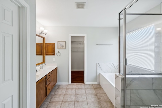 18310 Redwood Path, San Antonio, TX 78259 - full bathroom featuring double vanity, a garden tub, a spacious closet, tile patterned flooring, and an enclosed shower