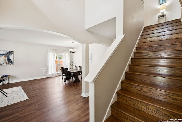 18310 Redwood Path, San Antonio, TX 78259 - staircase with arched walkways, wood finished floors, and a chandelier