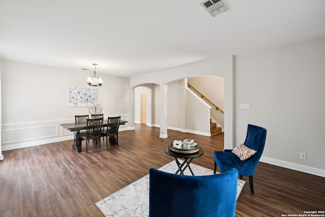 18310 Redwood Path, San Antonio, TX 78259 - dining area with arched walkways, wood finished floors, stairs, and a chandelier