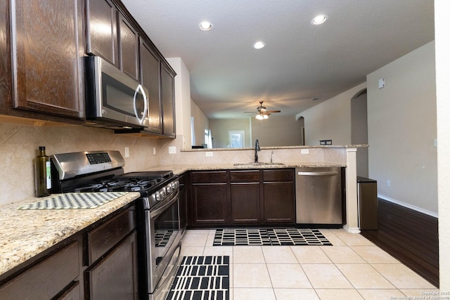 451 Tequila Rnch, San Antonio, TX 78245 - kitchen featuring stainless steel appliances, a ceiling fan, dark brown cabinets, tasteful backsplash, and recessed lighting
