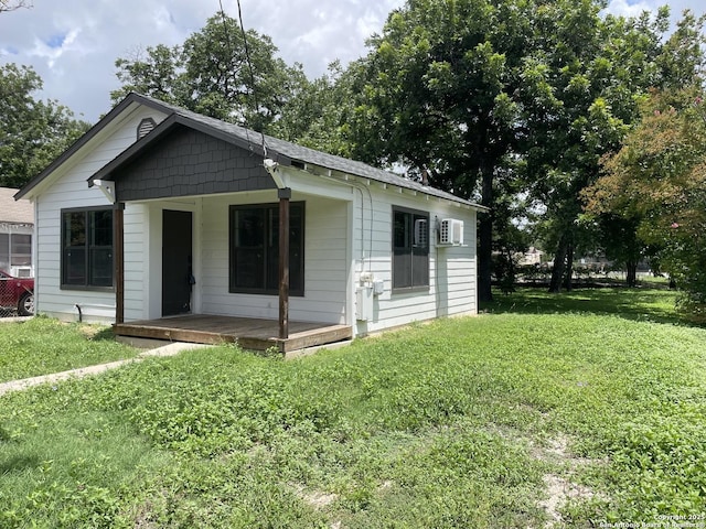 603 Humboldt, San Antonio, TX 78211 - bungalow-style house featuring a front lawn, covered porch, and a wall unit AC