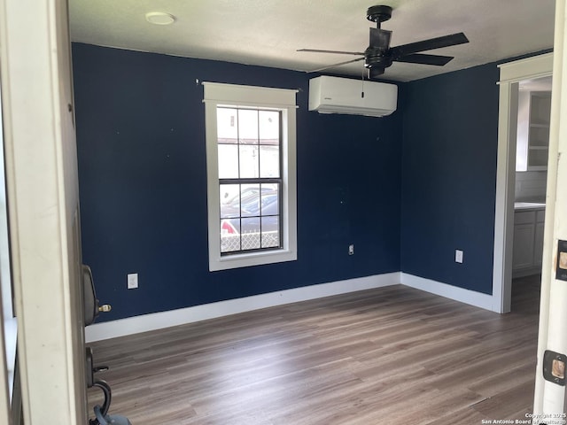 603 Humboldt, San Antonio, TX 78211 - empty room featuring a wall unit AC, wood finished floors, and ceiling fan