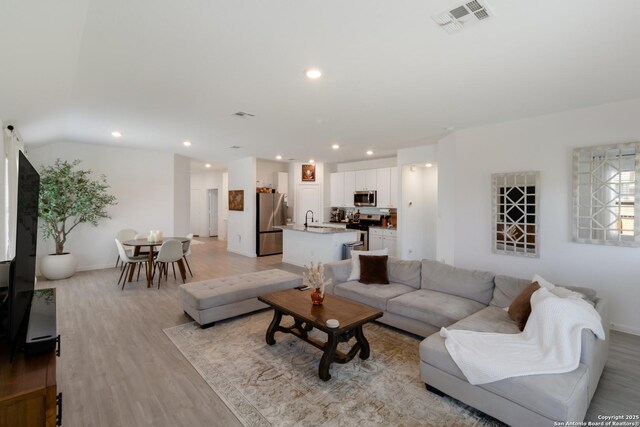 10626 Erinita, Converse, TX 78109 - living area featuring light wood-style floors and recessed lighting