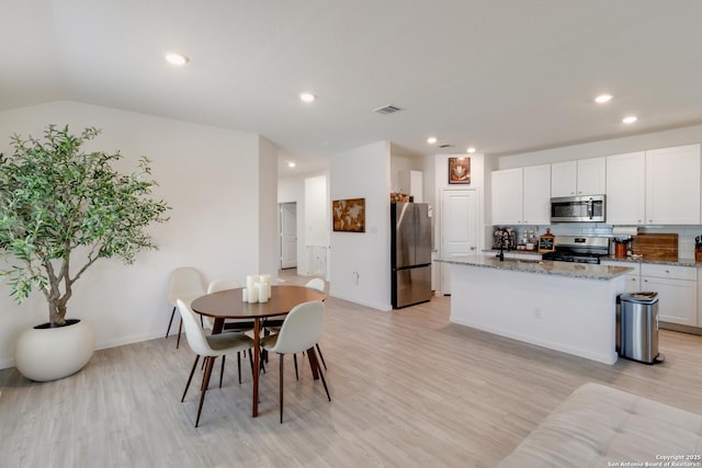 10626 Erinita, Converse, TX 78109 - dining space featuring light wood finished floors, recessed lighting, and lofted ceiling