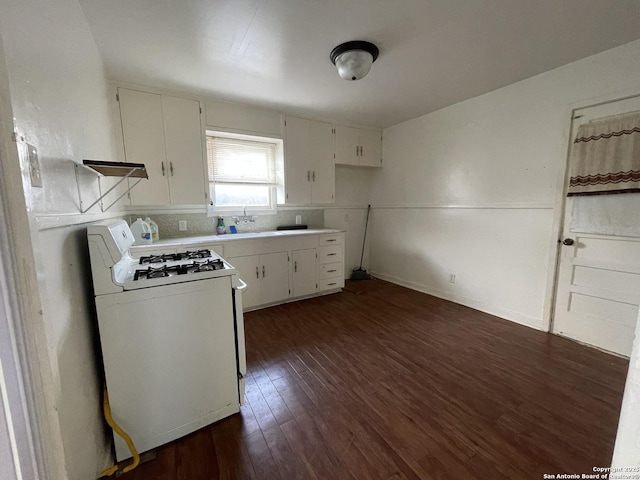 231 Carroll, San Antonio, TX 78225 - kitchen with white gas range oven, dark wood-type flooring, light countertops, tasteful backsplash, and white cabinetry