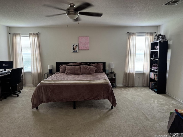 1038 Loma Mesa, San Antonio, TX 78214 - bedroom featuring light carpet, multiple windows, a textured ceiling, and a desk