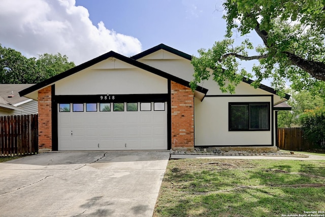 9818 Balanced Rock, Converse, TX 78109 - view of front of home with a garage, driveway, brick siding, and stucco siding