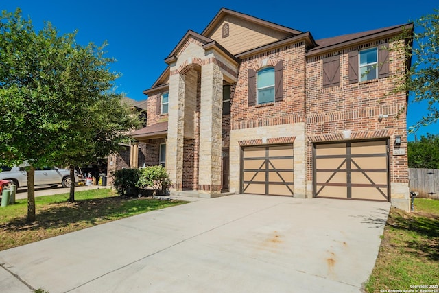 20131 Silver, San Antonio, TX 78259 - view of front of home featuring brick siding, driveway, an attached garage, and stone siding