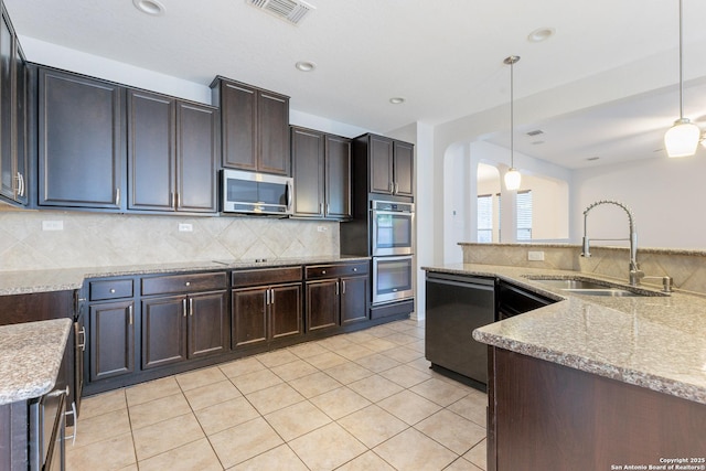 20131 Silver, San Antonio, TX 78259 - kitchen featuring appliances with stainless steel finishes, tasteful backsplash, pendant lighting, light stone counters, and recessed lighting