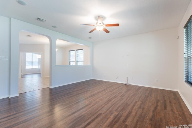 20131 Silver, San Antonio, TX 78259 - empty room with dark wood finished floors, ceiling fan, and arched walkways