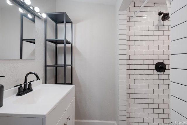 4914 Neer Ave, San Antonio, TX 78213 - bathroom with tiled shower, vanity, and a textured wall