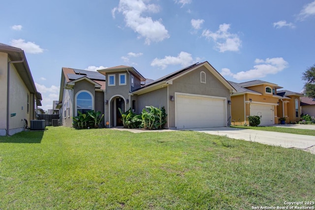 3915 Bacall, Converse, TX 78109 - view of front facade with stucco siding, a garage, solar panels, and concrete driveway