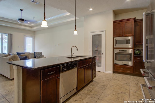 3915 Bacall, Converse, TX 78109 - kitchen featuring appliances with stainless steel finishes, a tray ceiling, decorative light fixtures, open floor plan, and recessed lighting