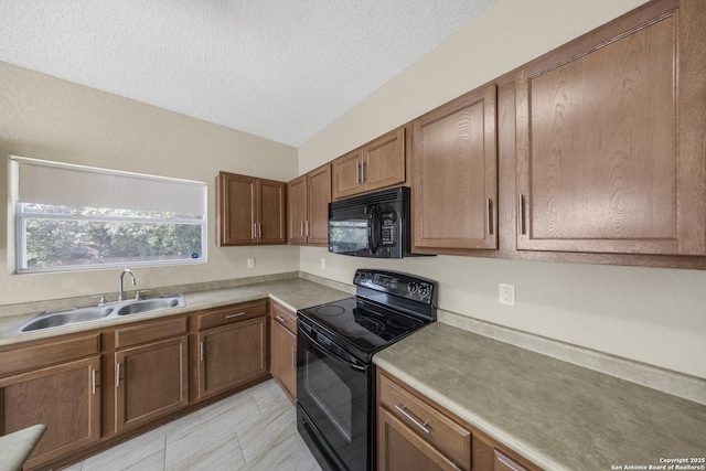 5715 Sendero Spg, San Antonio, TX 78251 - kitchen featuring black appliances, brown cabinets, a textured ceiling, and light countertops