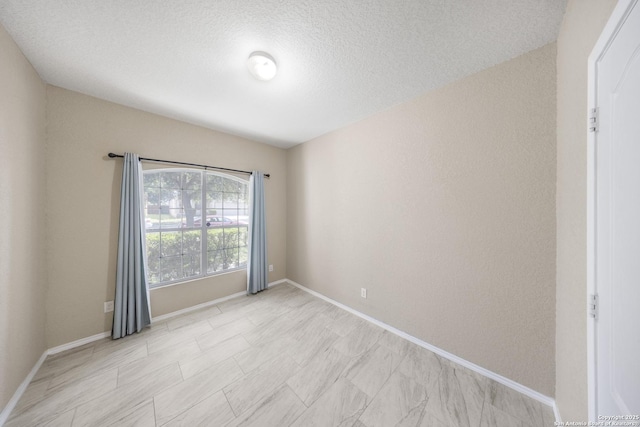 5715 Sendero Spg, San Antonio, TX 78251 - empty room with baseboards and a textured ceiling