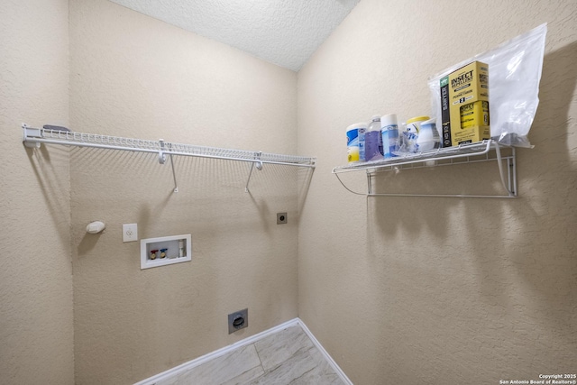5715 Sendero Spg, San Antonio, TX 78251 - laundry area featuring electric dryer hookup, hookup for a washing machine, and a textured ceiling