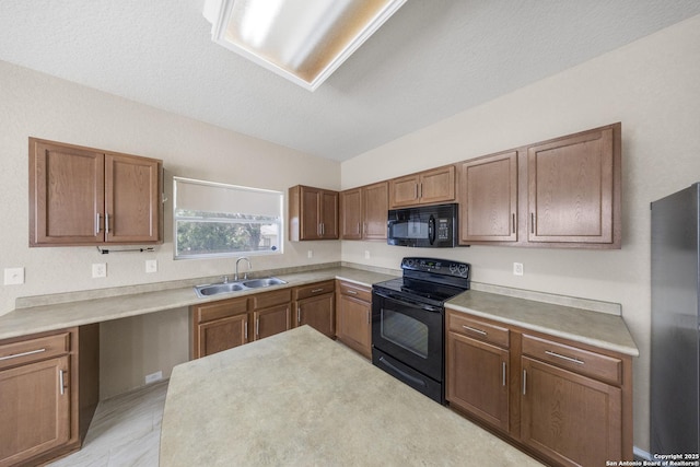 5715 Sendero Spg, San Antonio, TX 78251 - kitchen with black appliances, light countertops, and brown cabinetry