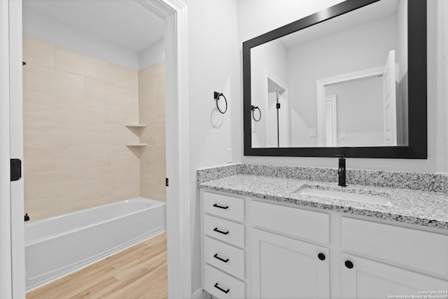 159 Azalea Aly, Castroville, TX 78009 - bathroom with vanity, wood finished floors, and bathtub / shower combination