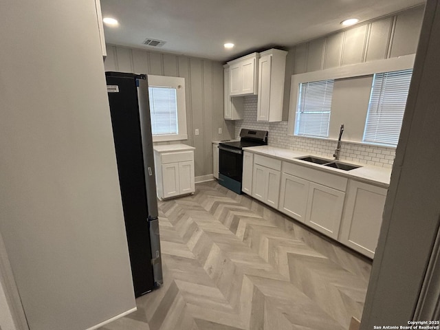 635 E Gonzales, Seguin, TX 78155 - kitchen featuring electric range, freestanding refrigerator, white cabinets, light countertops, and recessed lighting