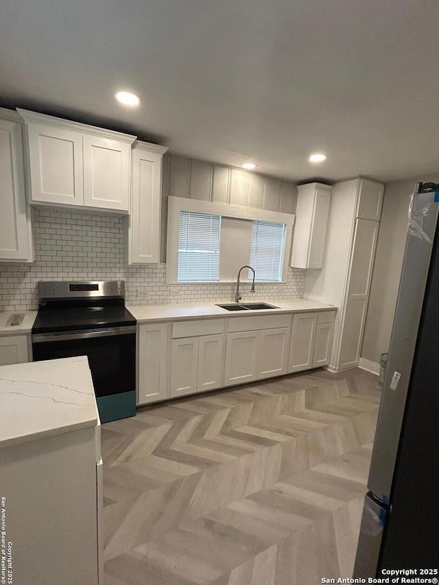 635 E Gonzales, Seguin, TX 78155 - kitchen featuring stainless steel appliances, white cabinetry, tasteful backsplash, light countertops, and recessed lighting