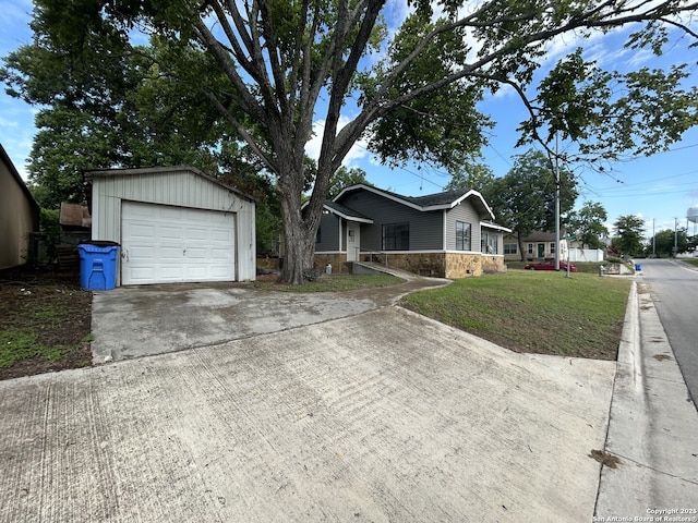 635 E Gonzales, Seguin, TX 78155 - single story home featuring stone siding, driveway, a garage, a front yard, and an outbuilding