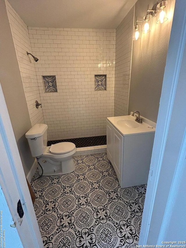 635 E Gonzales, Seguin, TX 78155 - bathroom featuring tile patterned floors, vanity, and a tile shower