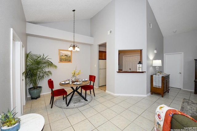 9536 W Dover Rdg, San Antonio, TX 78250 - dining room with a chandelier, high vaulted ceiling, and light tile patterned floors