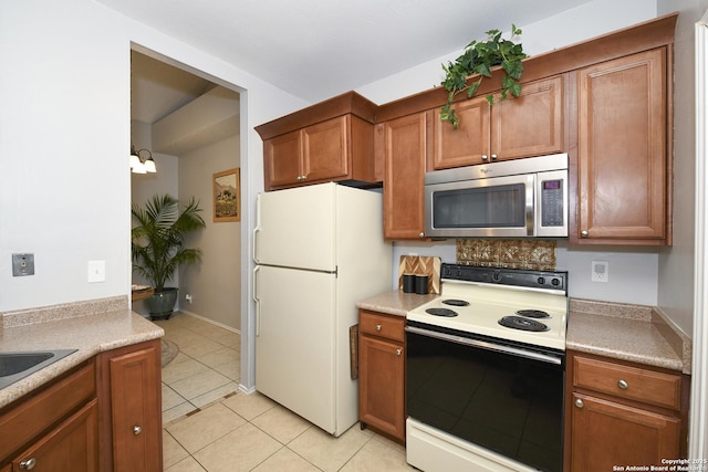 9536 W Dover Rdg, San Antonio, TX 78250 - kitchen featuring white appliances, light tile patterned flooring, light countertops, and brown cabinets