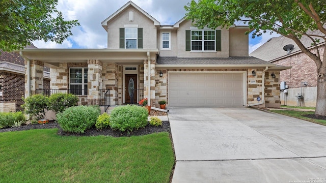 12618 Ozona Rnch, San Antonio, TX 78245 - traditional-style house featuring a garage, concrete driveway, covered porch, stone siding, and a front lawn