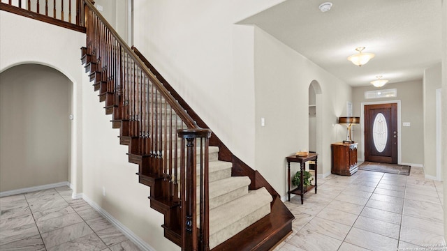 12618 Ozona Rnch, San Antonio, TX 78245 - foyer with light marble finish floors, arched walkways, and stairs