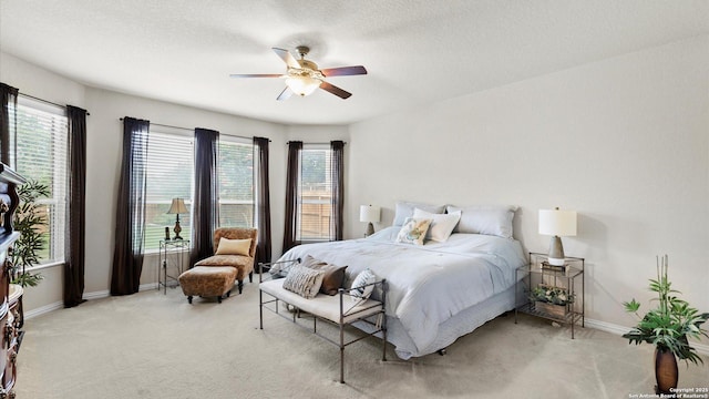 12618 Ozona Rnch, San Antonio, TX 78245 - bedroom with light carpet, multiple windows, a ceiling fan, and a textured ceiling