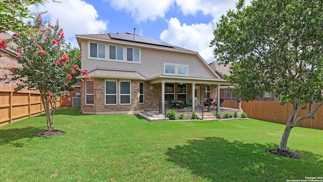 12618 Ozona Rnch, San Antonio, TX 78245 - back of property featuring a fenced backyard, solar panels, a patio area, stucco siding, and brick siding