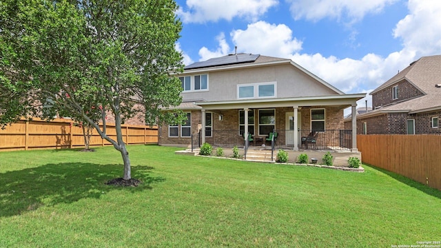 12618 Ozona Rnch, San Antonio, TX 78245 - back of property with roof mounted solar panels, stucco siding, a fenced backyard, and brick siding