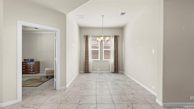 12618 Ozona Rnch, San Antonio, TX 78245 - unfurnished dining area with light marble finish flooring and a chandelier