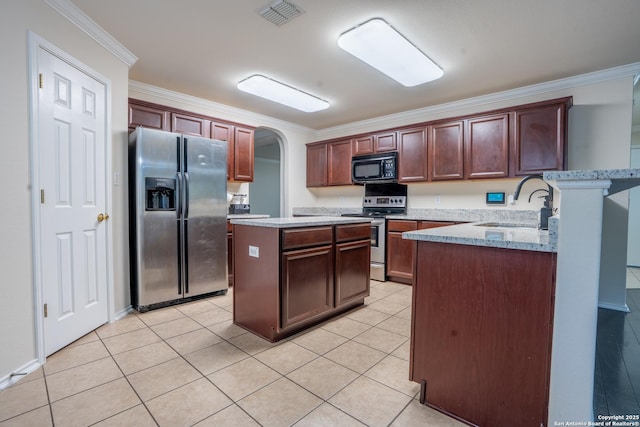 9534 Anderson Way, Converse, TX 78109 - kitchen featuring appliances with stainless steel finishes, crown molding, arched walkways, a kitchen island, and light tile patterned floors