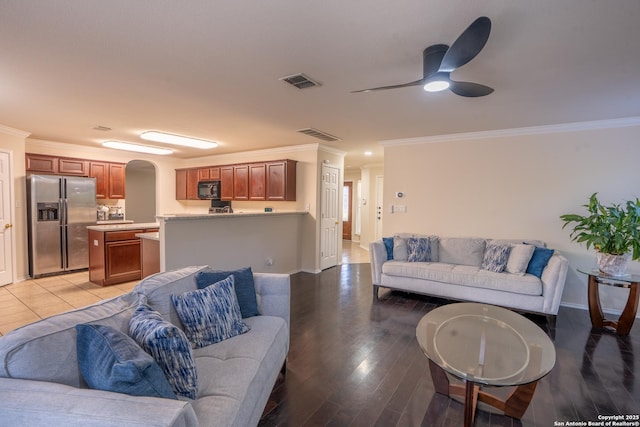 9534 Anderson Way, Converse, TX 78109 - living area featuring ornamental molding, a ceiling fan, arched walkways, and light wood-style flooring