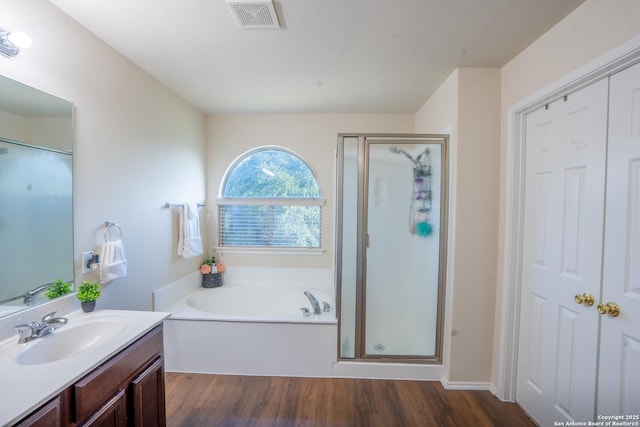 9534 Anderson Way, Converse, TX 78109 - bathroom featuring vanity, wood finished floors, a shower stall, and a garden tub