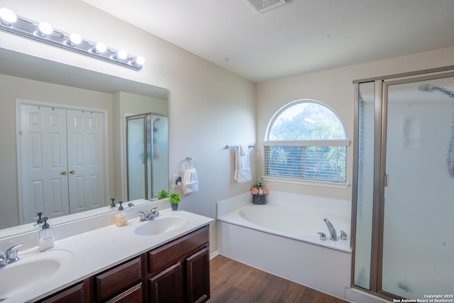 9534 Anderson Way, Converse, TX 78109 - bathroom featuring a shower stall, wood finished floors, a garden tub, and double vanity