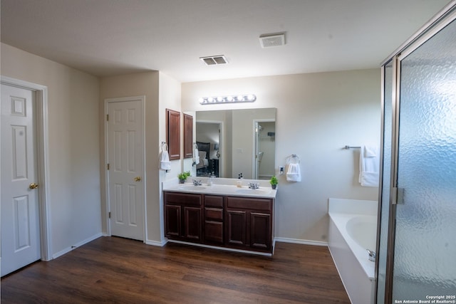 9534 Anderson Way, Converse, TX 78109 - full bathroom with wood finished floors, a bath, and double vanity