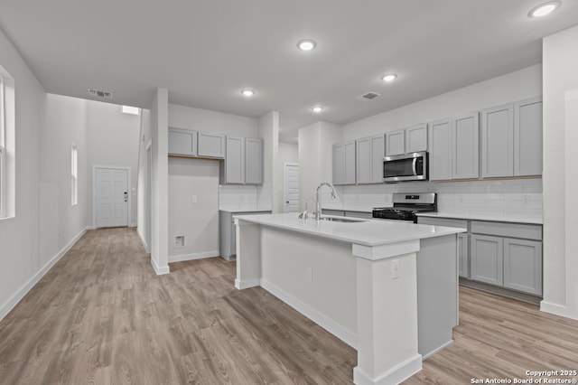9962 Forestier Grn, San Antonio, TX 78214 - kitchen with stainless steel microwave, electric range oven, gray cabinetry, and recessed lighting