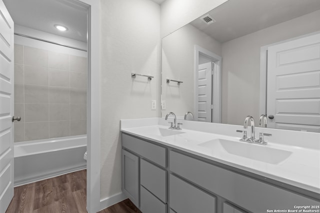9962 Forestier Grn, San Antonio, TX 78214 - full bathroom with wood finished floors, double vanity, and  shower combination