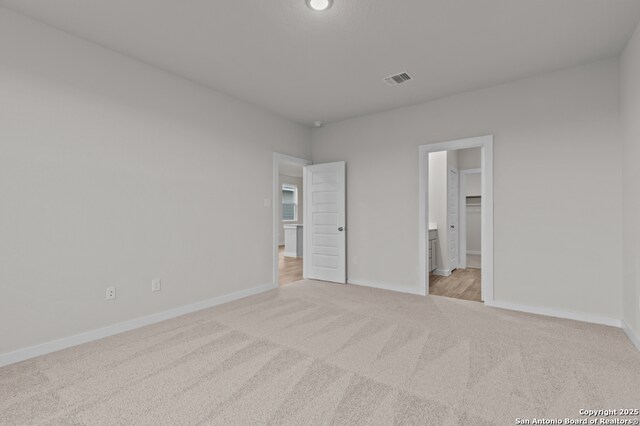 9962 Forestier Grn, San Antonio, TX 78214 - unfurnished bedroom with light colored carpet and baseboards