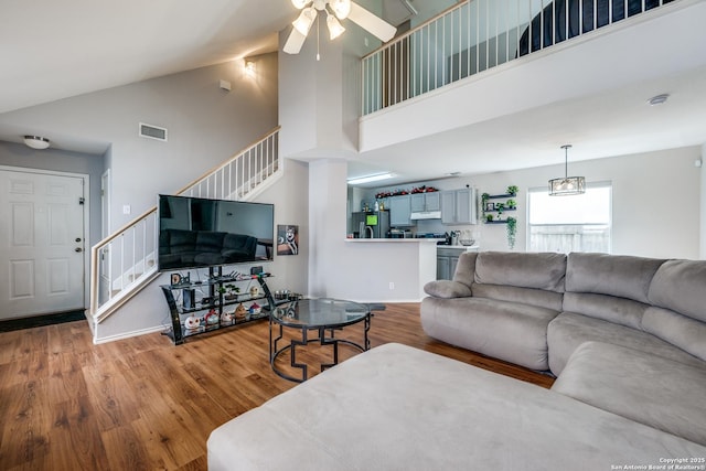 9406 Gillcross, San Antonio, TX 78250 - living room with stairs, high vaulted ceiling, a ceiling fan, and wood finished floors