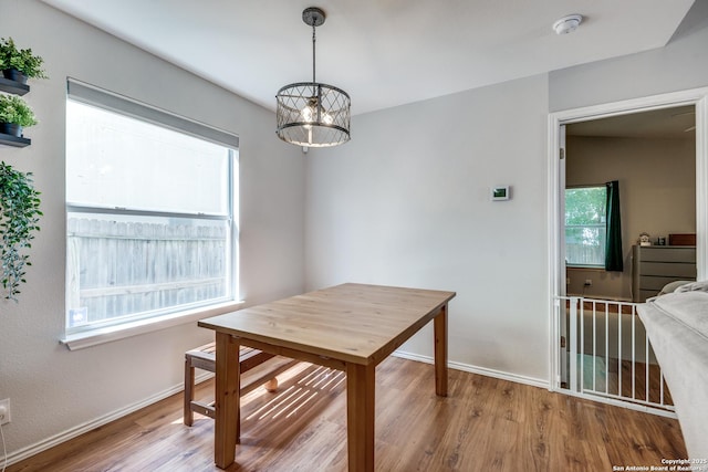 9406 Gillcross, San Antonio, TX 78250 - dining space with a chandelier, wood finished floors, and plenty of natural light