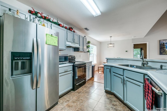 9406 Gillcross, San Antonio, TX 78250 - kitchen with appliances with stainless steel finishes, under cabinet range hood, light countertops, and pendant lighting