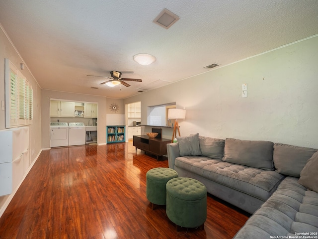 110 W Hermine Blvd, San Antonio, TX 78212 - living room featuring washing machine and dryer, dark wood-type flooring, ceiling fan, a textured ceiling, and ornamental molding