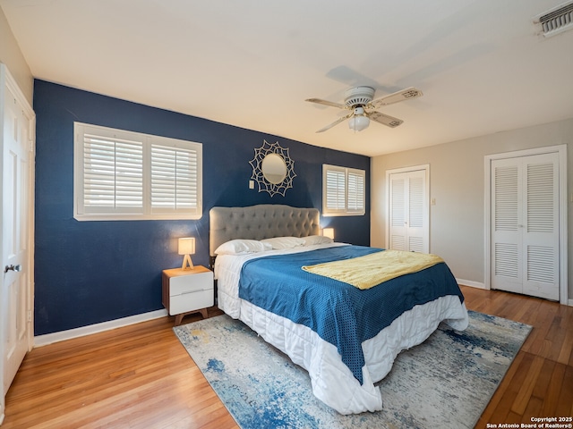 110 W Hermine Blvd, San Antonio, TX 78212 - bedroom featuring two closets, wood finished floors, multiple windows, and ceiling fan