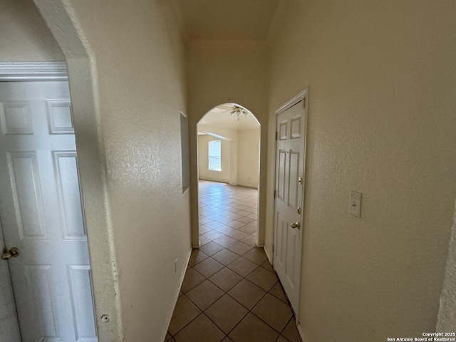 6547 Estes Flts, San Antonio, TX 78242 - corridor with tile patterned floors, arched walkways, crown molding, and a textured wall